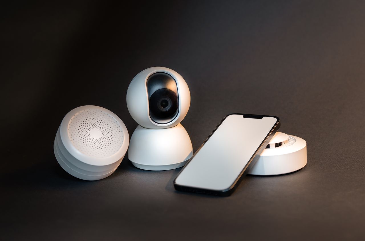 The Art of Drawing Readers In: Your attractive post title goes here A sleek smartphone with modern smart home devices on a minimalist gray background.